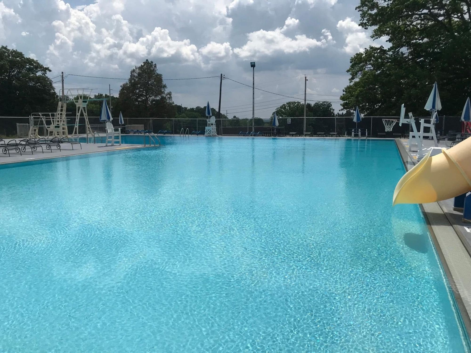 outdoor pool with diving board and slide